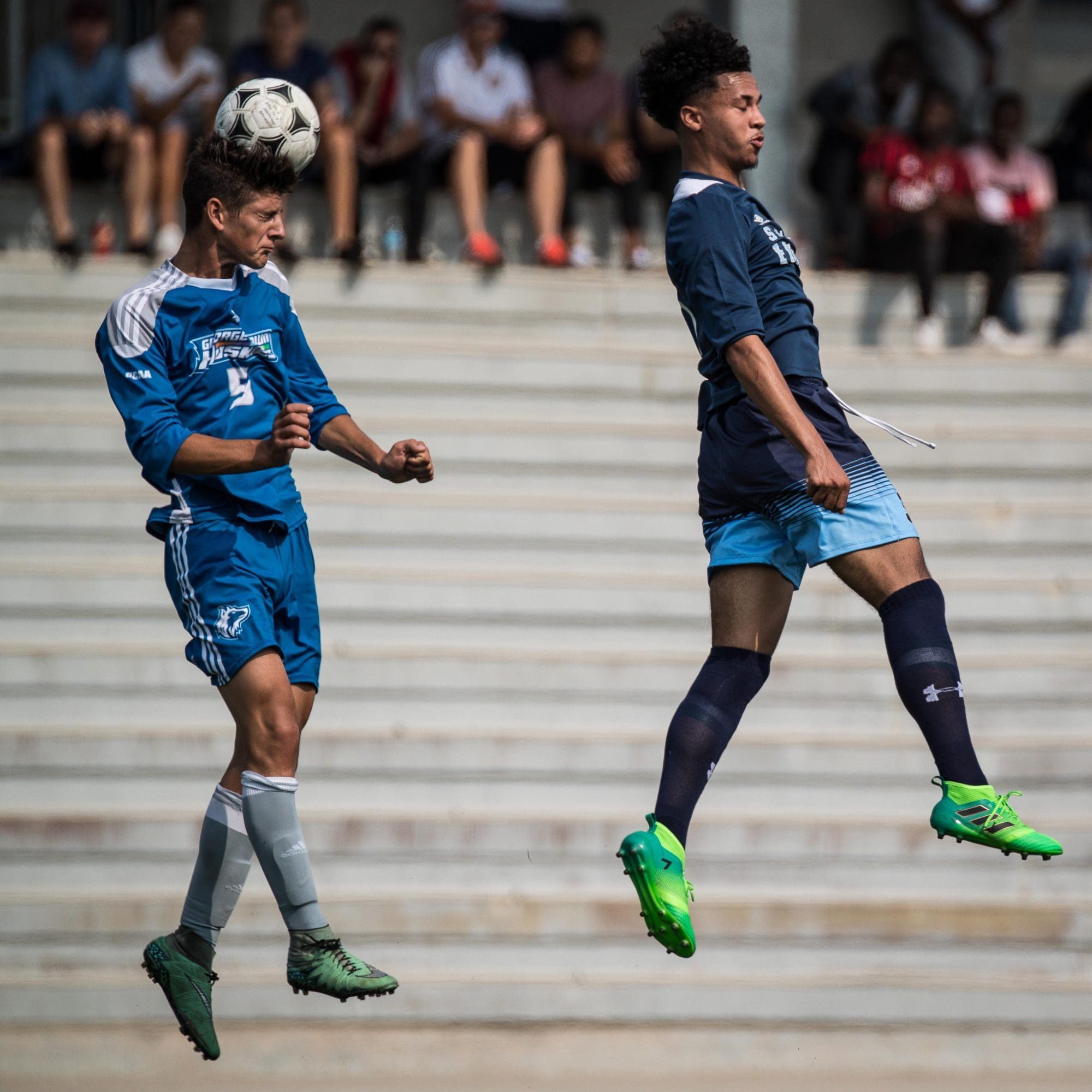 OAKVILLE, ON – SEP. 16, 2017: Players go airborne for the header in a game between the Sheridan Bruins and the George Brown Huskies.
