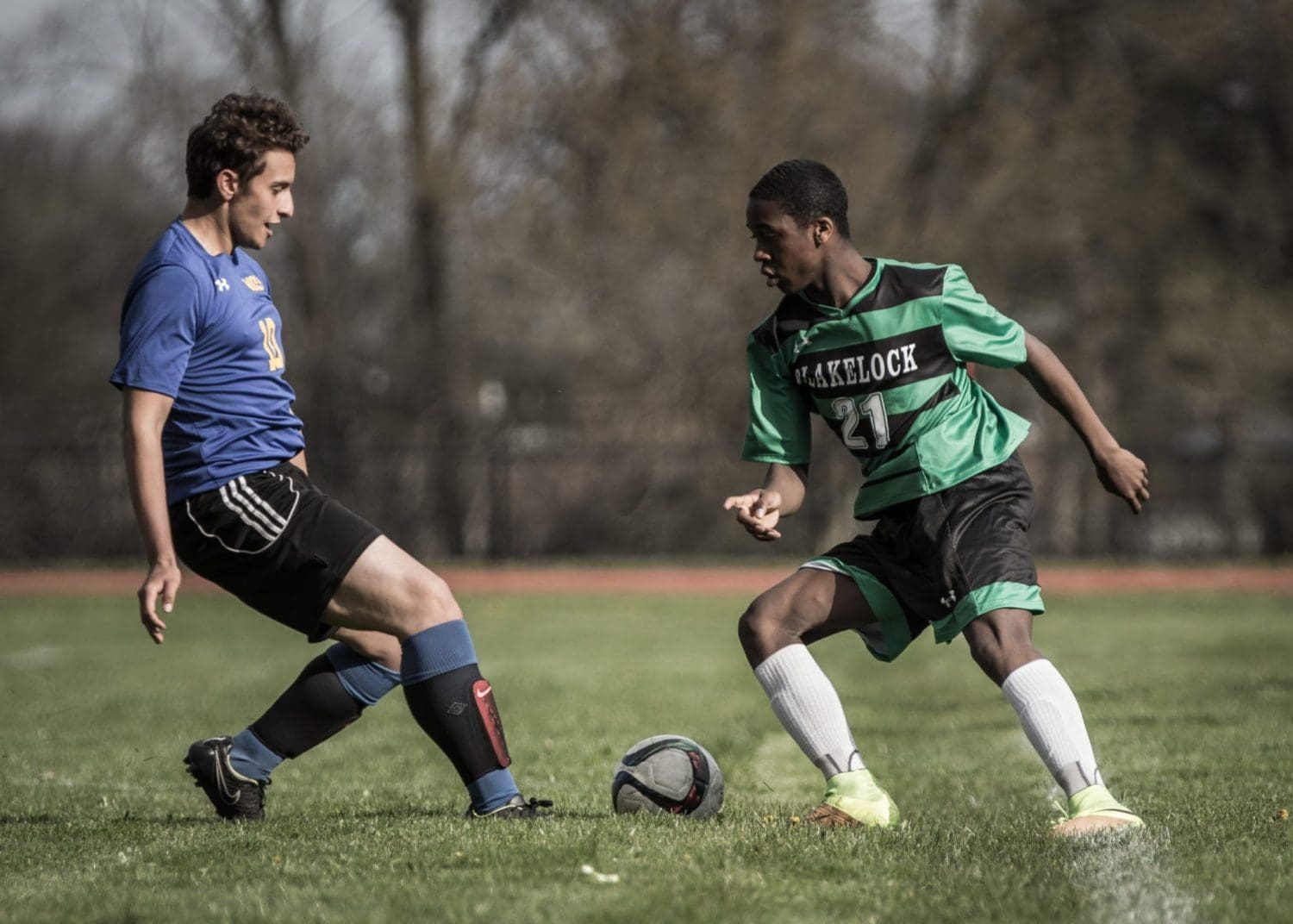 OAKVILLE, ON – MAY 5, 2016: A player from T. A. Blakelock challenges a White Oaks opponent with the ball at his feet.
