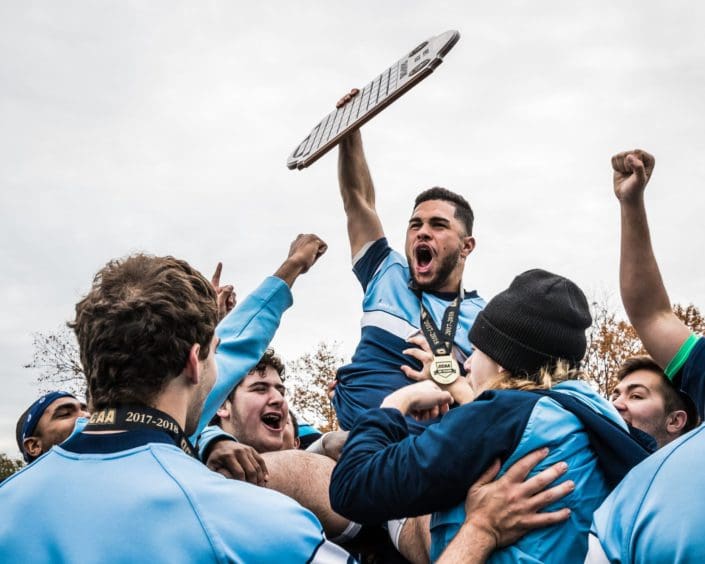Ontario Colleges Athletic Association game between the Sheridan Bruins and the St. Lawrence Vikings OAKVILLE, ON - NOV. 12, 2017: Jad Hamade of the Sheridan Bruins hoists the OCAA Men's Rugby Championship plaque into the air after a victory against the St. Lawrence Vikings.