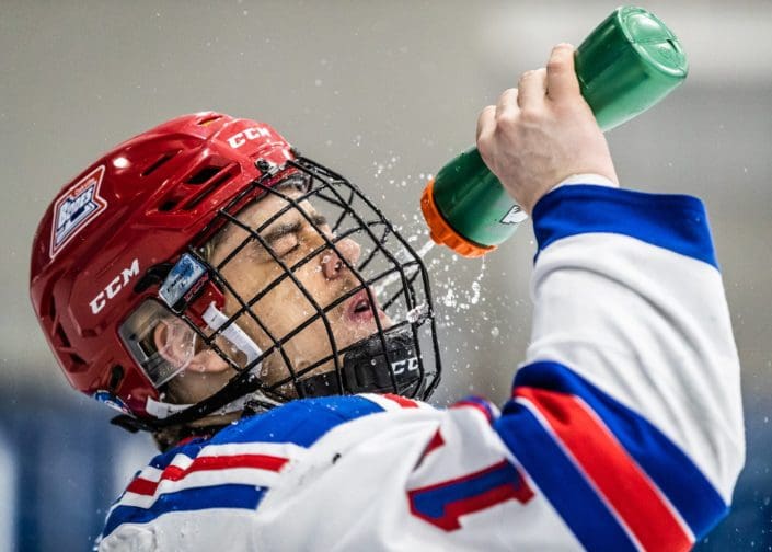 OAKVILLE, ON – APR. 2, 2019: Callum Jones of the Oakville Blades sprays himself with water during pre-game warm-ups. OAKVILLE, ON - APR. 2, 2019: Callum Jones of the Oakville Blades sprays himself with water during pre-game warm-ups.