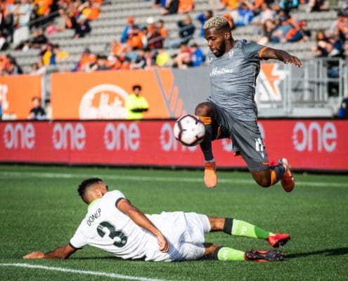 HAMILTON, ON - OCT. 6, 2019: Christopher Nanco of Forge FC jumps over Morey Doner of York9 FC in Canadian Premier League action.