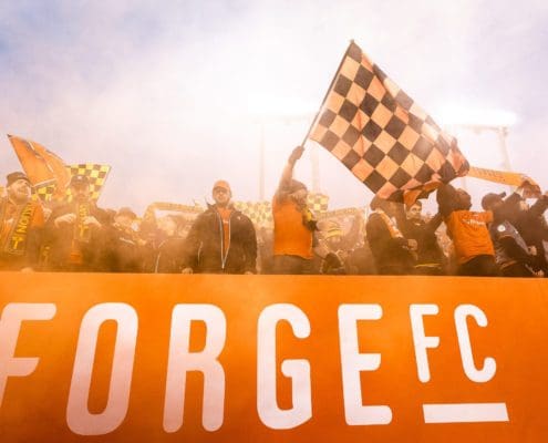 HAMILTON, ON - OCT. 26, 2019: Forge FC fans celebrate at Tim Hortons Field after a 1-0 win over Cavalry FC in the first leg of the Canadian Premier League Finals.